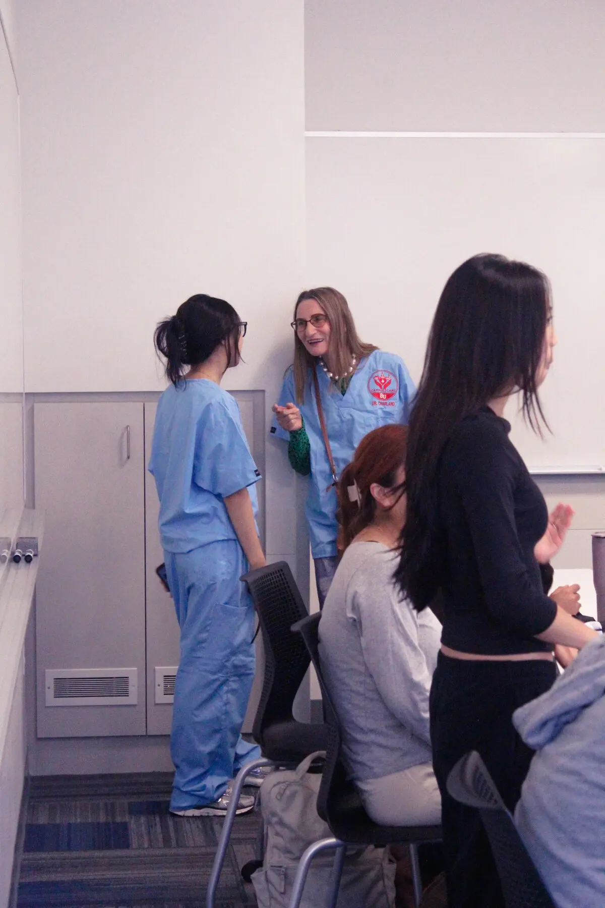 Campus2Care faculty advisor speaking with a student at a workshop